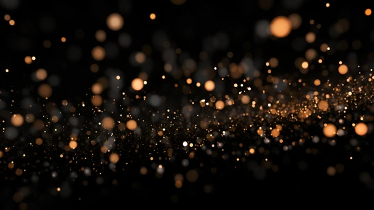 Schwarzer Hintergrund mit vielen leuchtenden orangen Bokeh-Lichtpunkten in unscharfer Verteilung.